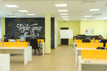 Semalt open-space office with the “Triple your efforts” wall